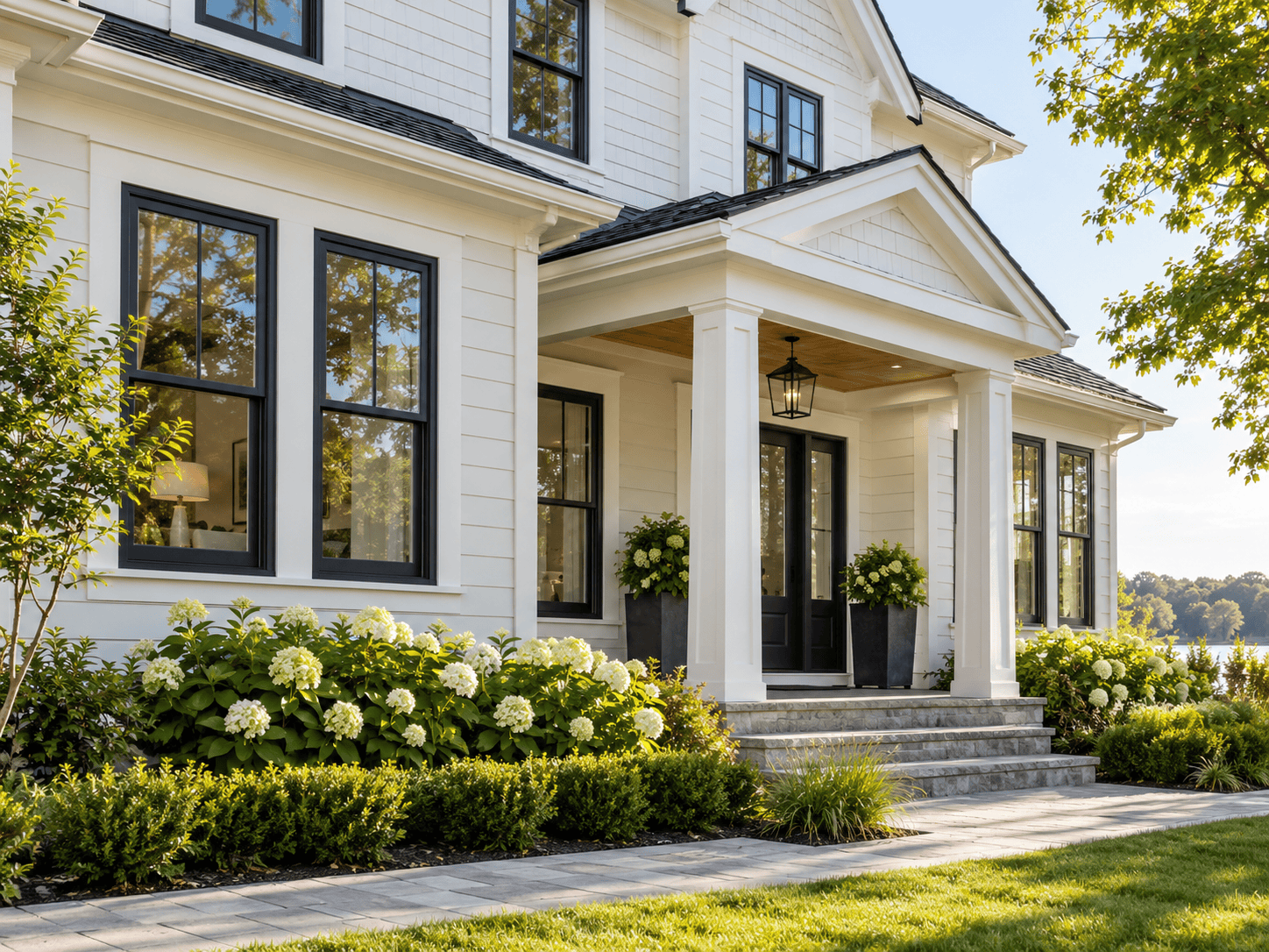 White home exterior featuring black-framed double-hung windows.