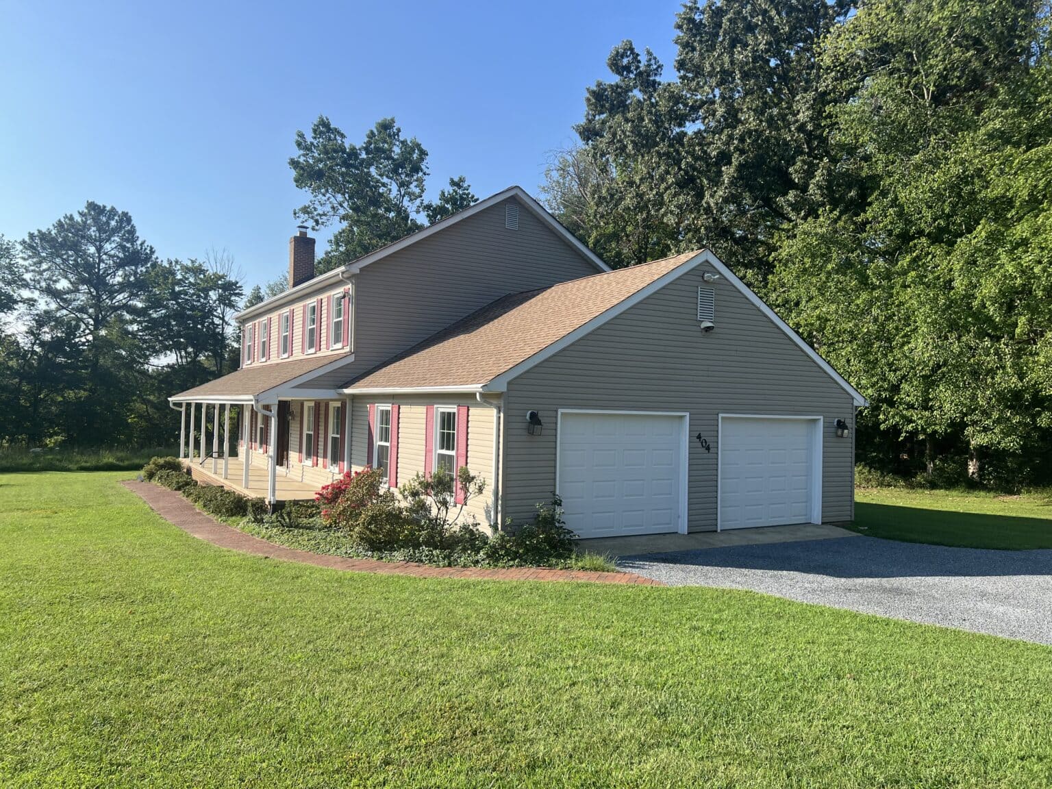 Gray residential home with white-framed windows and an attached garage.