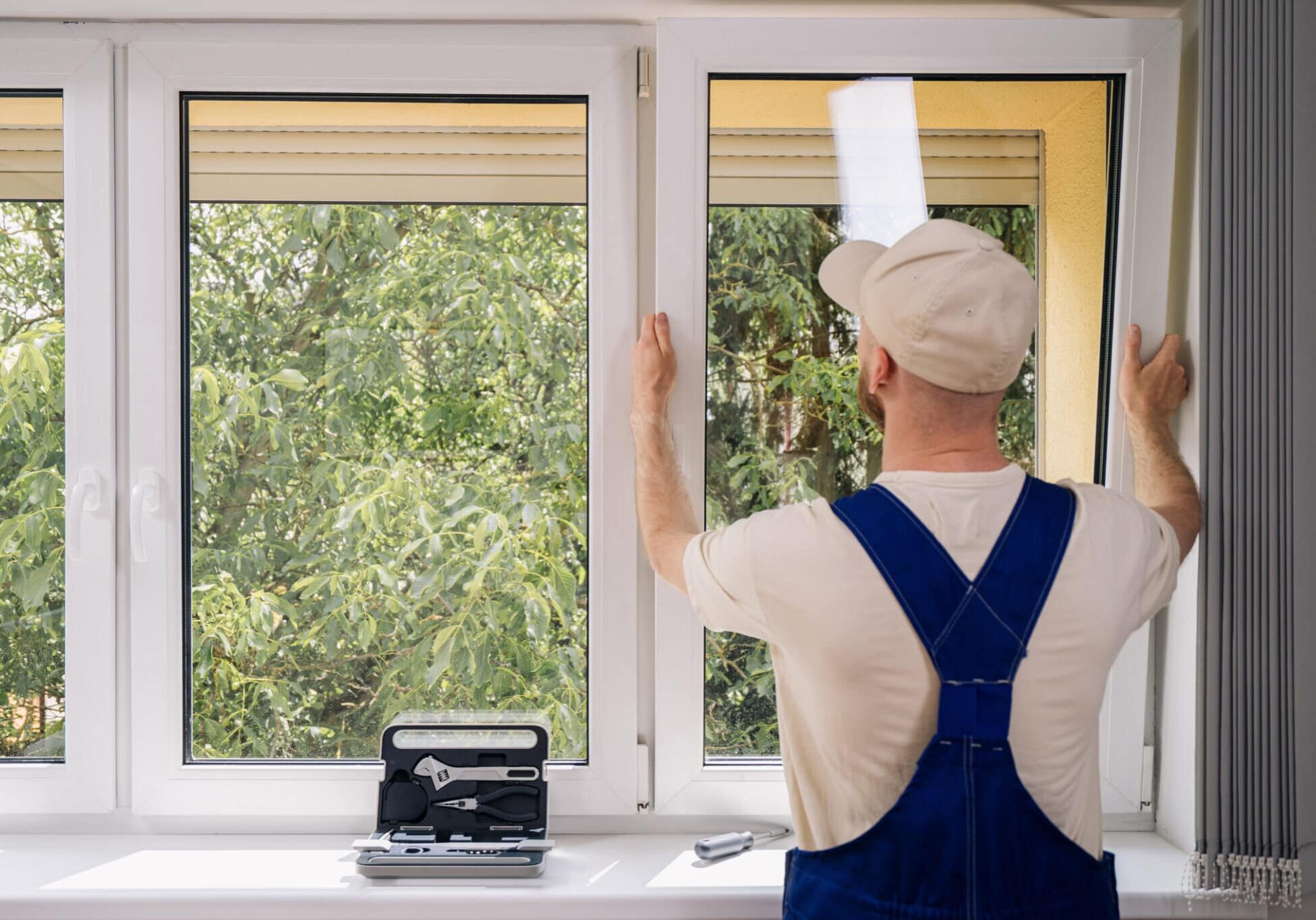 Installer fitting a replacement window